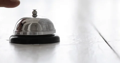 Man ringing hotel reception bell, male hand pushing accommodation call bell on Stock Footage 94871340