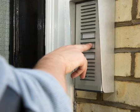 Man ringing an intercom to gain access Stock Photos
