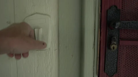 A man ringing an old fashioned mechanical doorbell Stock Footage 242938040