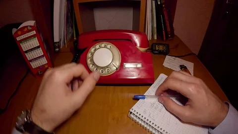 A man is ringing on an old red phone Stock Footage 74171028
