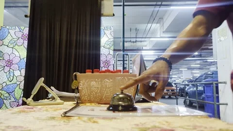 Man Ringing Service Bell on Counter in Professional Setting Stock Footage 328713949