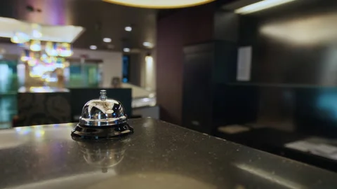 Man Ringing Service Bell on Hotel Reception Desk with Receptionist Approaching Stock Footage 342131627