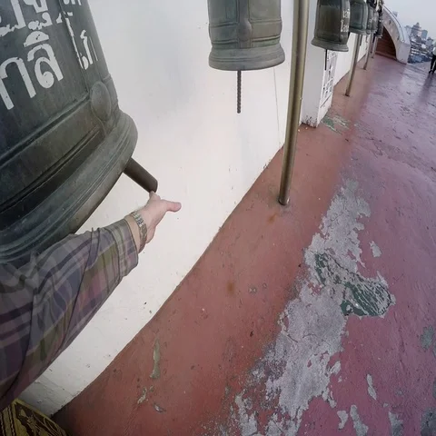 A man rings the bell in the temple. Taking the first-person Stock Footage 69515098