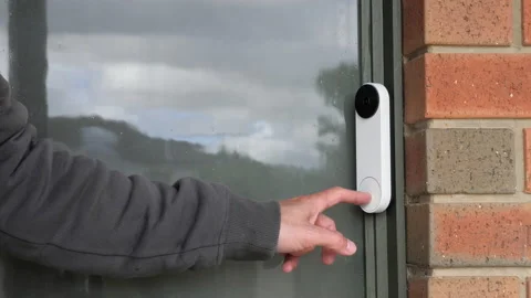 Man Rings Smart Doorbell Security Camera Device At Front Door Of Home Stock Footage 165136609