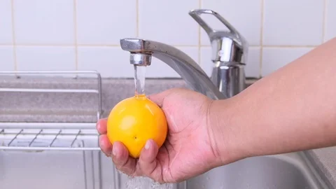 Man Rinsing Orange Fruit Stock Footage 95962730