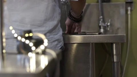 A man rinsing vegetable in a sink  Stock Footage 145354883