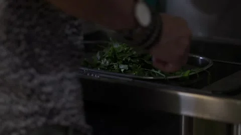 A man rinsing vegetable in a sink Stock Footage 146250203