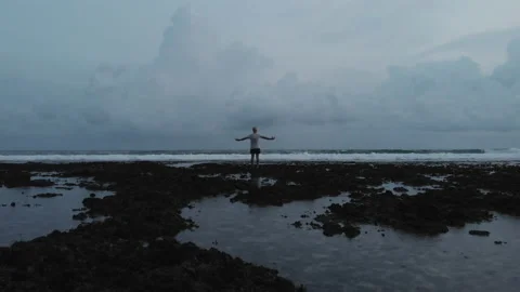 Man rising hands up on beach Stock-Footage 130716302