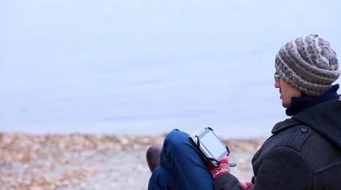 Man on the River Bank Using a Tablet Stock Footage 56639775