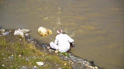 A Man on the Riverbank Stock Footage 321038624
