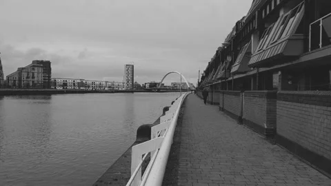 Man on riverside walkway Stock Footage 171889956