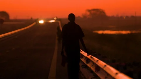 Man on the road at dusk Stock Footage 129291291
