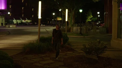 Man Roams a Dark City Stock Footage 77208936