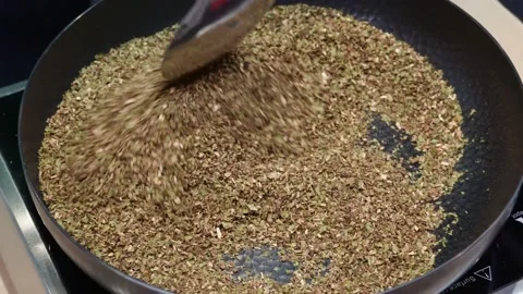 A man roasting dried tea leaves in a pan Stock Footage 197776270