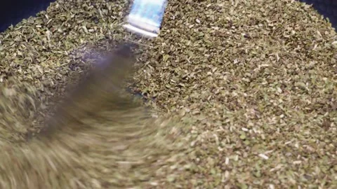 A man roasting dried tea leaves in a pan Stock Footage 197778609