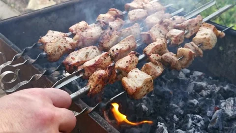 A man roasts a barbecue on the grill. Video stock 144476630
