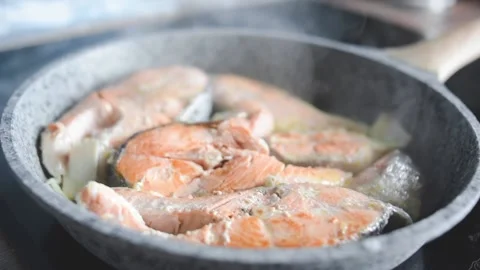 A man roasts fish Stock Footage 131493163