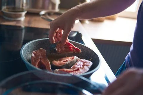 A man roasts fish Stock Photos