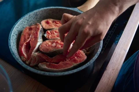 A man roasts fish Stock Photos