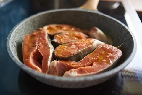 A man roasts fish Photos