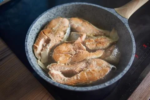 A man roasts fish Stock Photos
