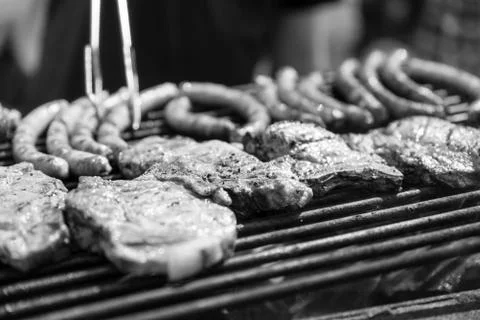 Man roasts meat, bbq, weekends. Monochrome effect Fotos Stock
