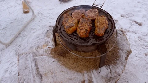 Man roasts steaks on grill Stock Footage 105564373