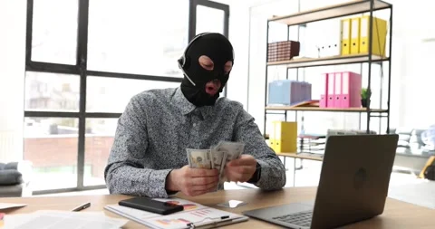 Man in robber mask talks into microphone counting money Vidéo 240092789