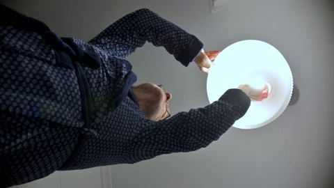 Man In Robe Installing Ceiling Light During Home Improvement Project Stock Footage 329906315