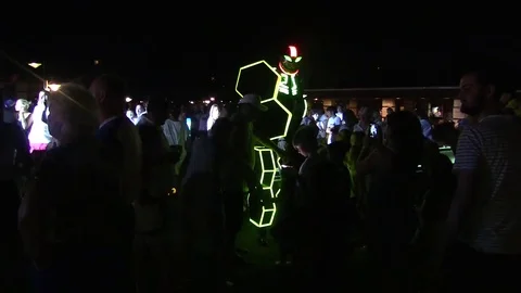 Man in robot glowing dynamo suit communicate with people crowd Stock Footage 78589492