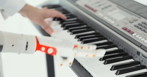Man with robotic prosthesis hand playing the piano. Playing two hands, a robotic Video stock 106221114