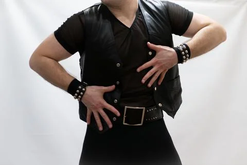 A man in rock clothes performs dance moves. A metal man with a mohawk on hi.. Stock Photos