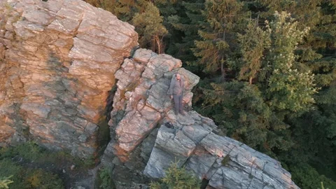 Man on the rock during sunset drone view Stock Footage 201471057