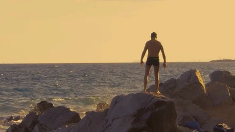 Man on rock Stockbeeldmateriaal 78647491