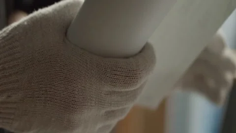 Man with a roll of paper in his hands Stock Footage 271549700