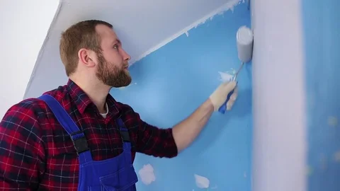 Man with roller painting wall Stock Footage 75048755