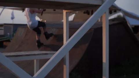 Man on roller skates jumping in a skate park Video stock 102776143