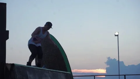 Man on roller skates performs tricks on springboards Video stock 102786771