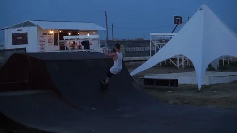 Man on roller skates performs tricks and jump on the wall Video stock 102787284