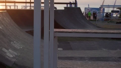 Man on roller skates rides back forward and jumps on the springboard Stock-Footage 102776318
