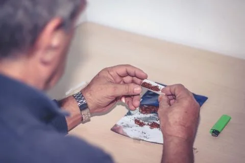 Man rolling a cigarette 스톡 사진