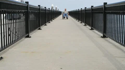 Man Rolling Forward Wheelchair Stock Footage 12679446