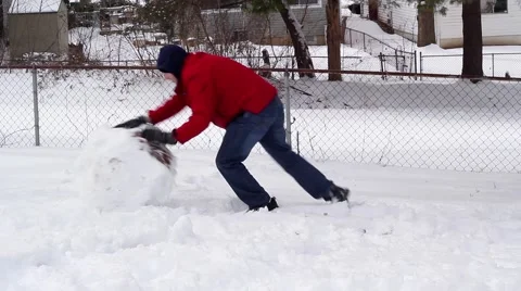 Man Rolling a Large Snow Ball 스톡 동영상 47979248