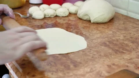 Man Rolling Out Dough On Kitchen Table. He Is A Chef In This Kitchen. Stock Footage 132563667