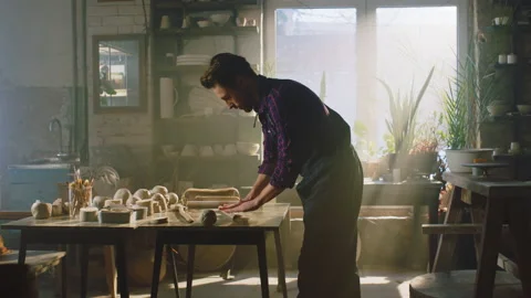 Man Is Rolling Out Piece of Raw Clay Stock Footage 170025987