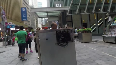 The man rolling a refrigerator is passing by, camera slide move, Hong Kong Stock Footage 143393683