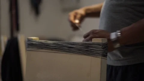 A man rolling string on the back chair at work Stock Footage 97495957