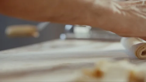 Man rolling thin layers of dough Stock Footage 274606776