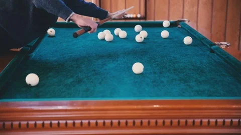 Man rolls the ball into the hole Stock Footage 81544376