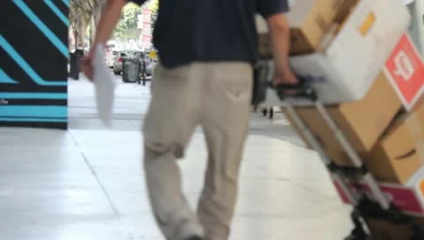 Man Rolls Dolly Of Mail Stock Footage 11360890